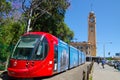 Red light rail running on the track at Pitt St. with Iconic central railway station clock tower at the background. Royalty Free Stock Photo